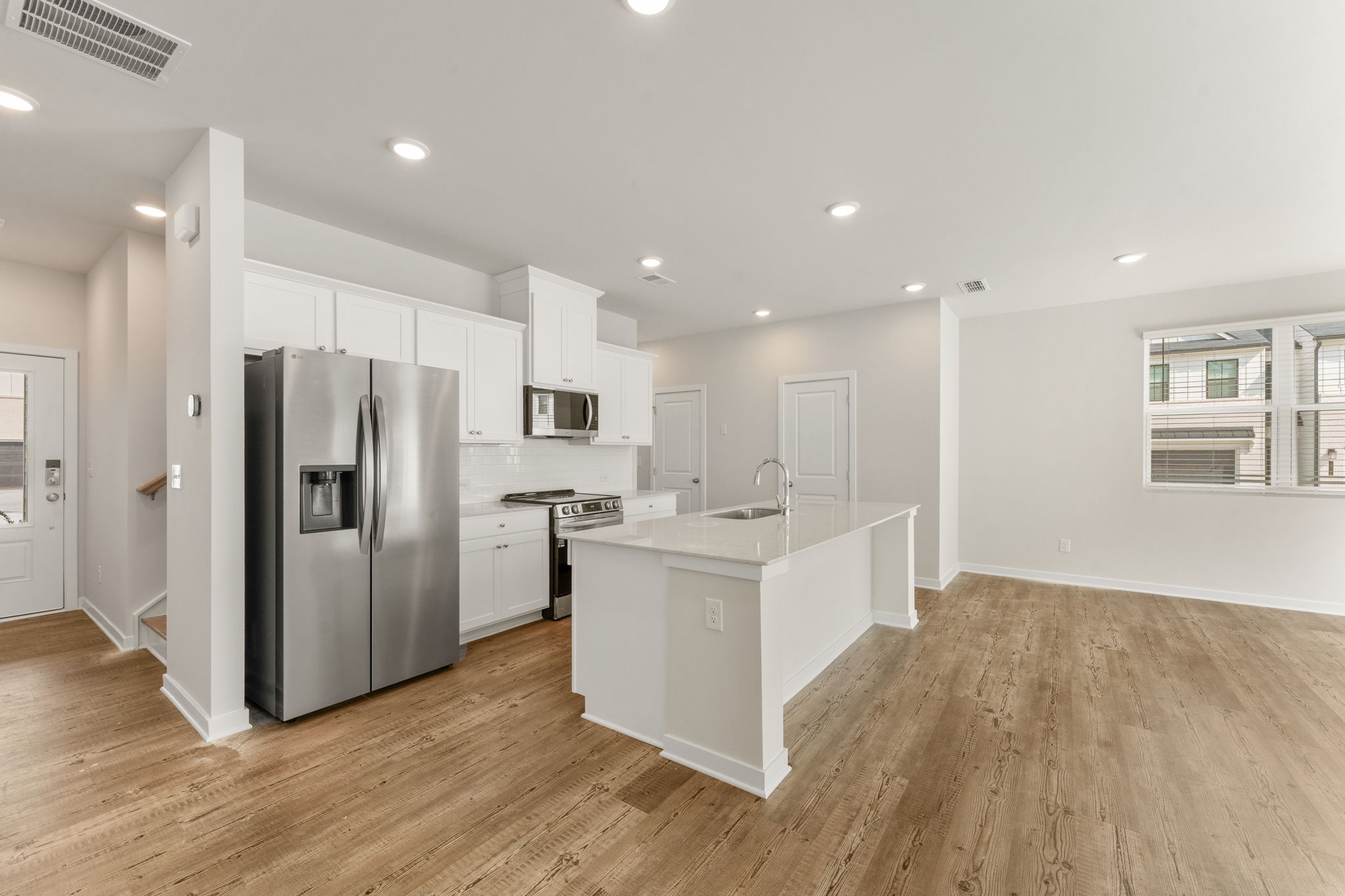 A kitchen with white cabinets.