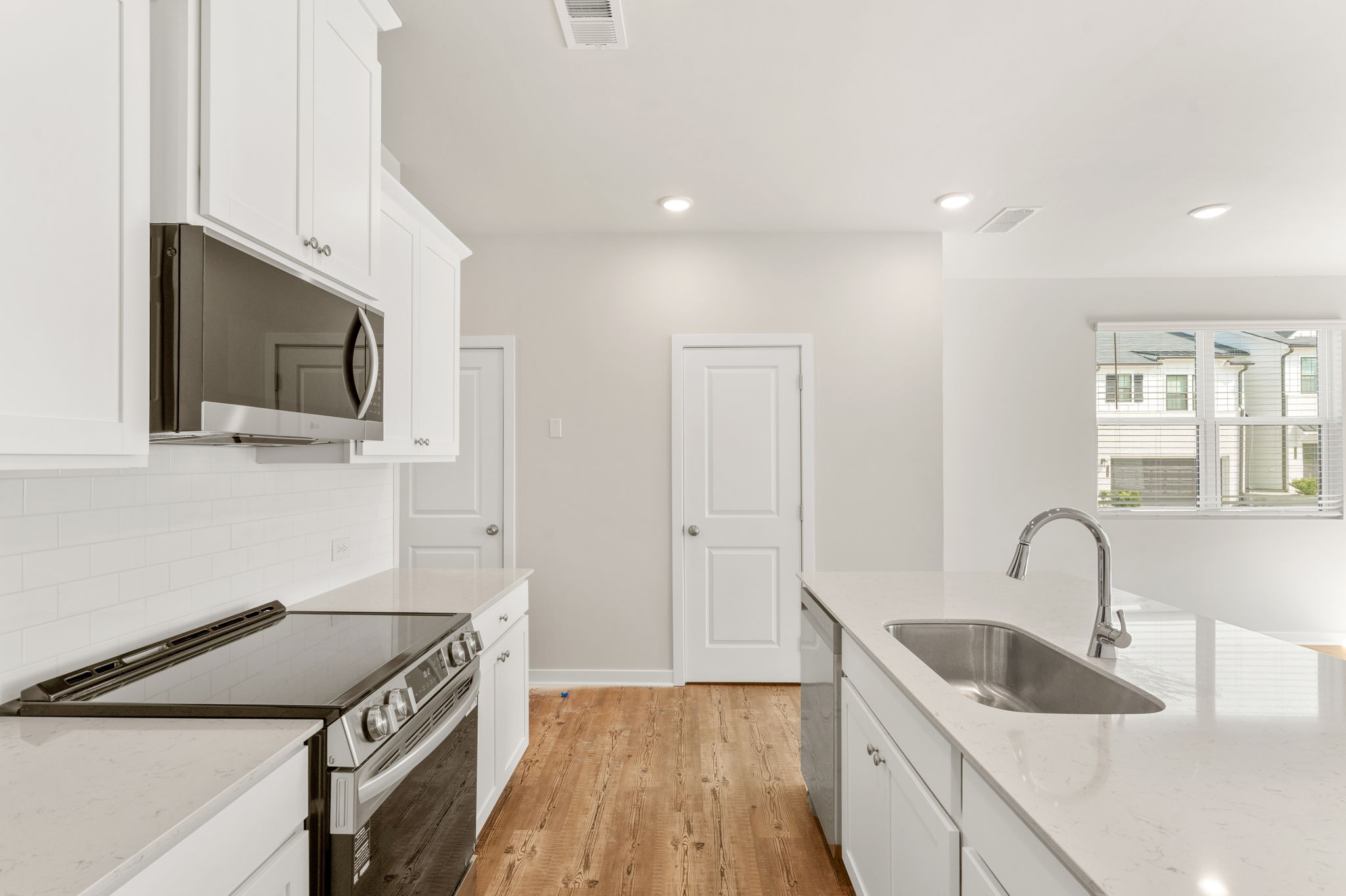 A kitchen with white cabinets.