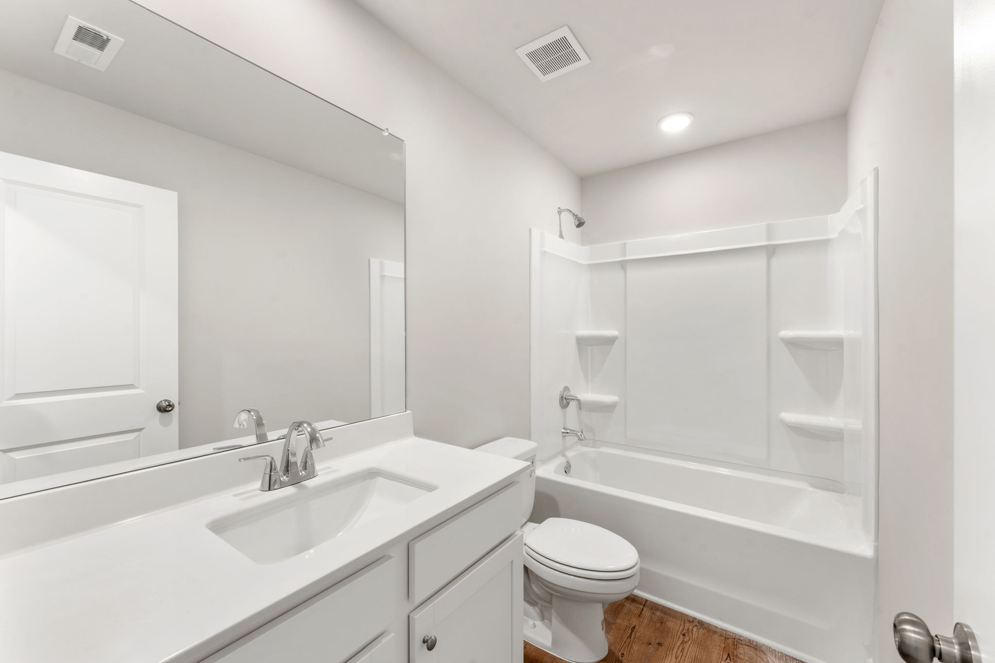 A bathroom with a tub sink and toilet.