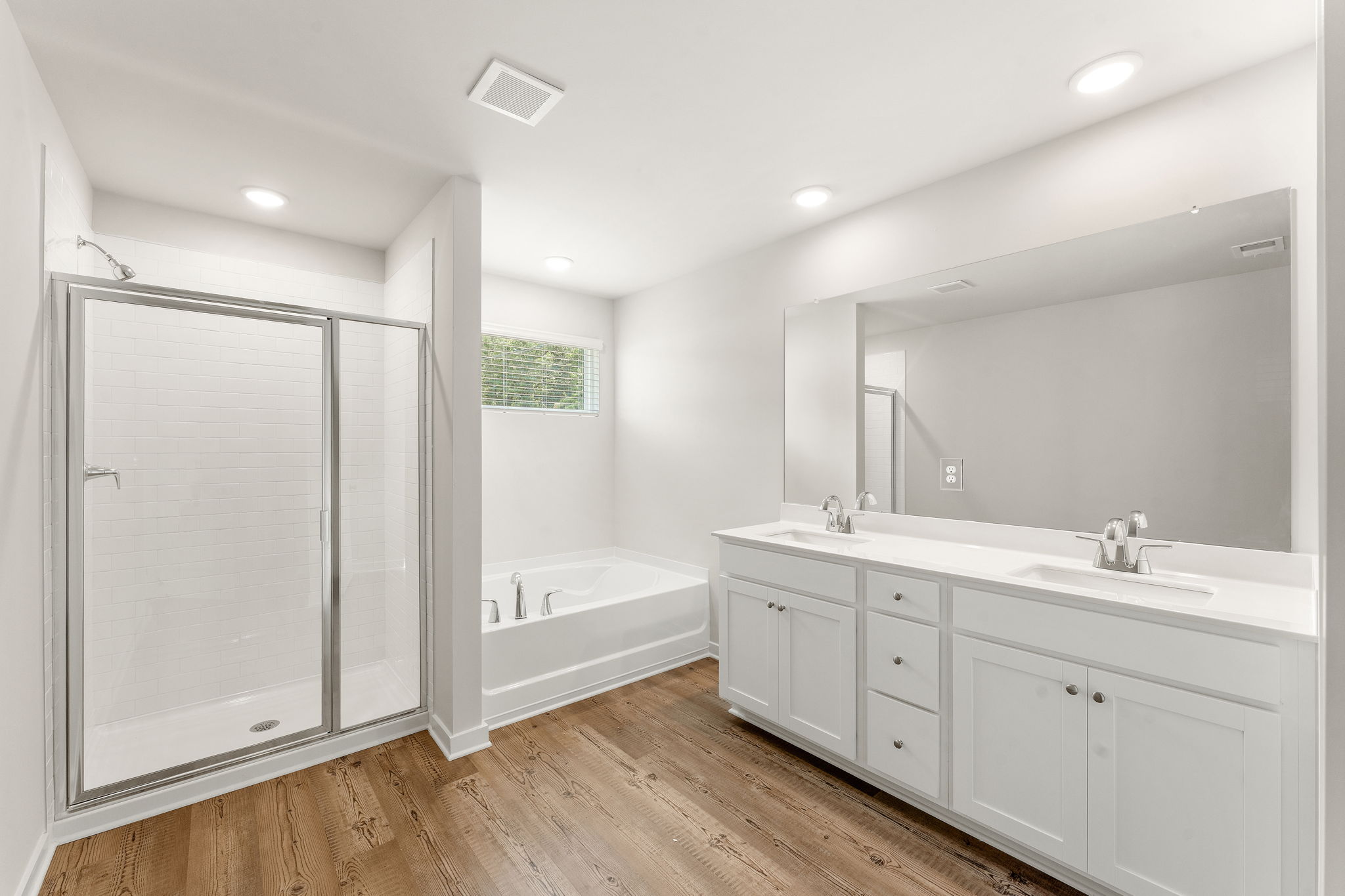A bathroom with a tub sink and a shower.