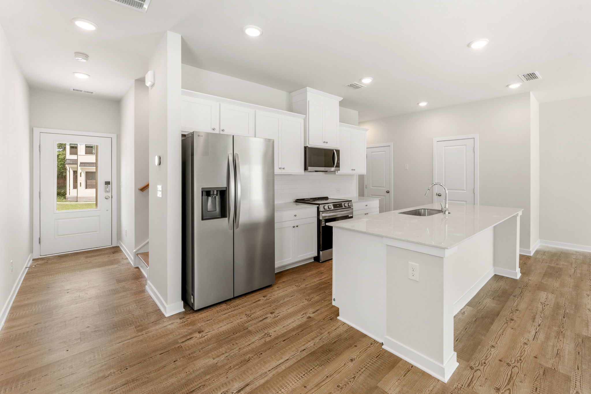A kitchen with white cabinets.