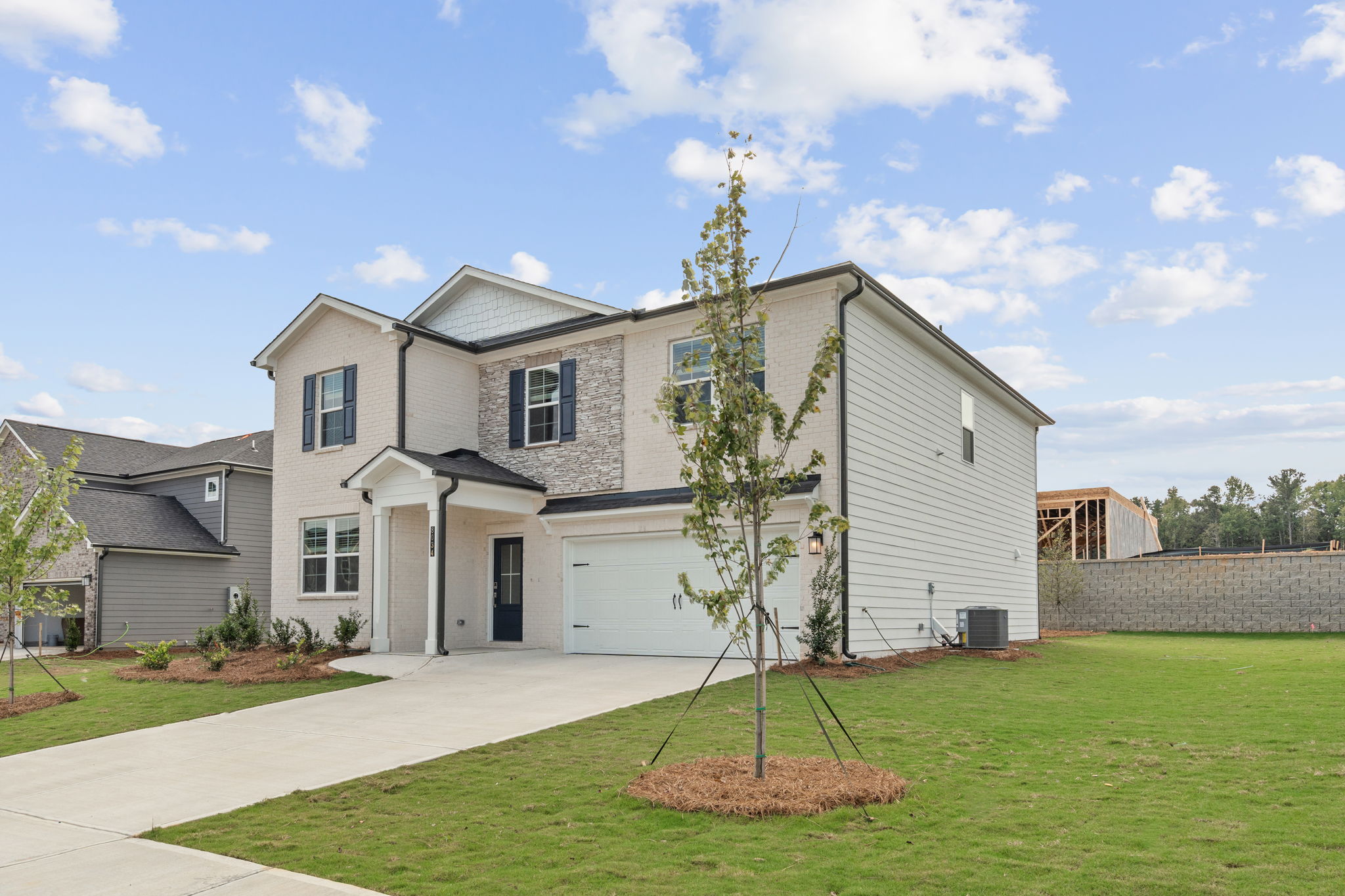 A house with a tree in the front yard.
