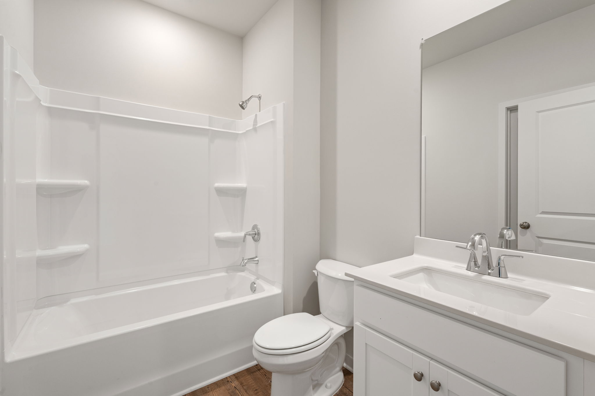 A bathroom with a tub sink and toilet.