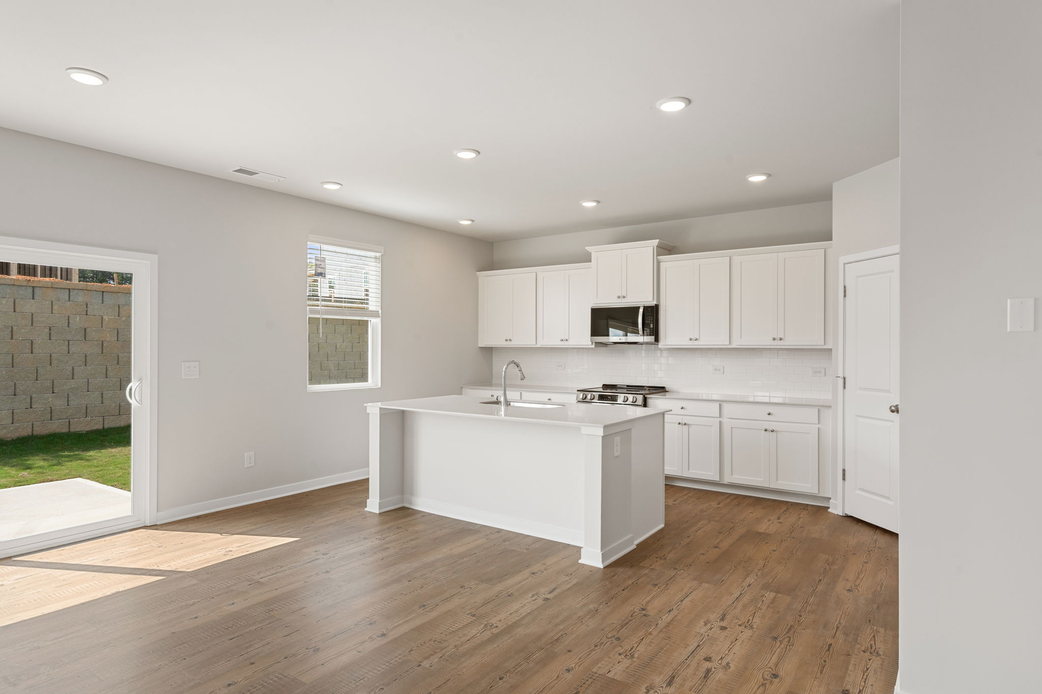 A kitchen with white cabinets.