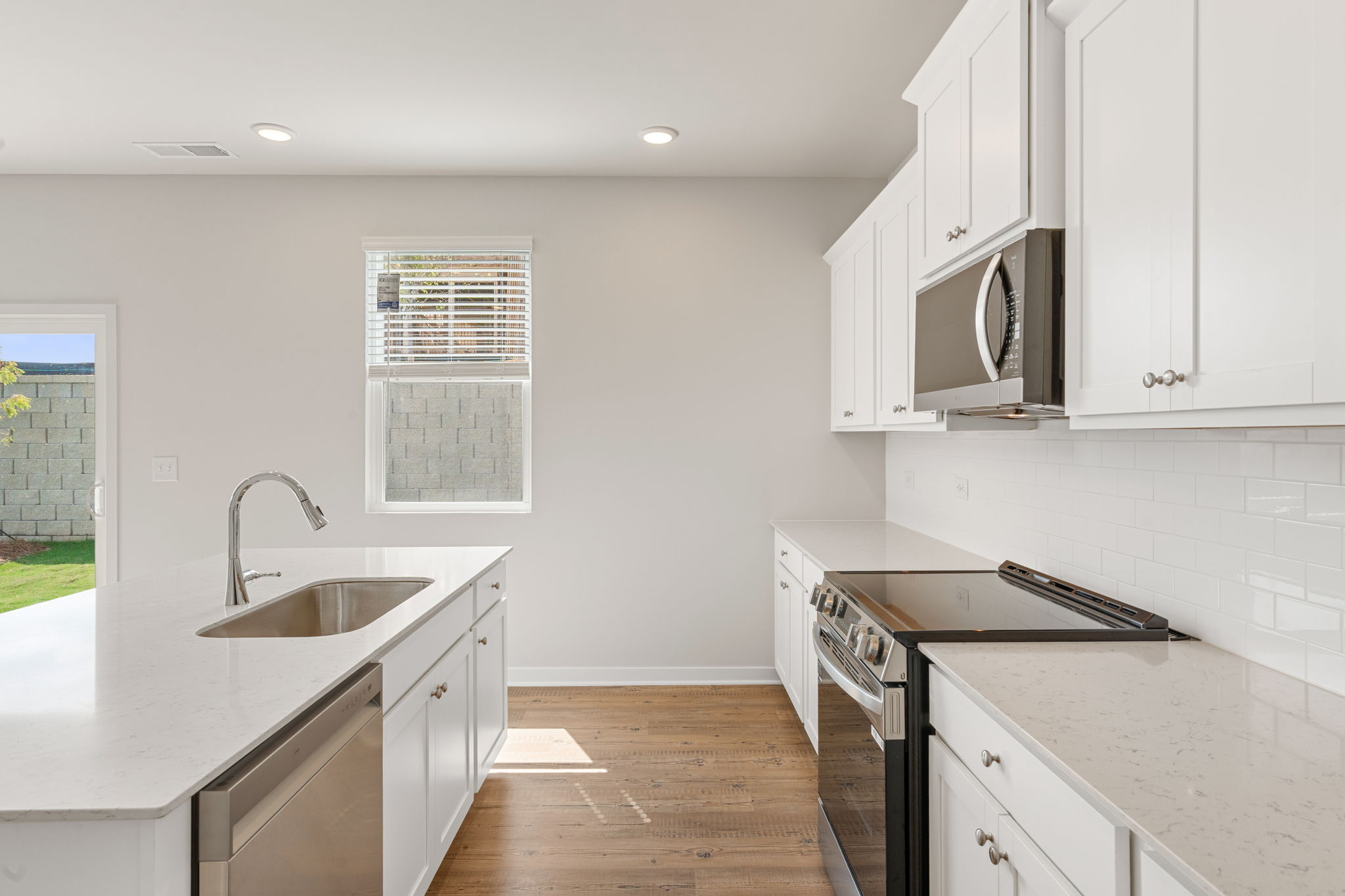 A kitchen with white cabinets.