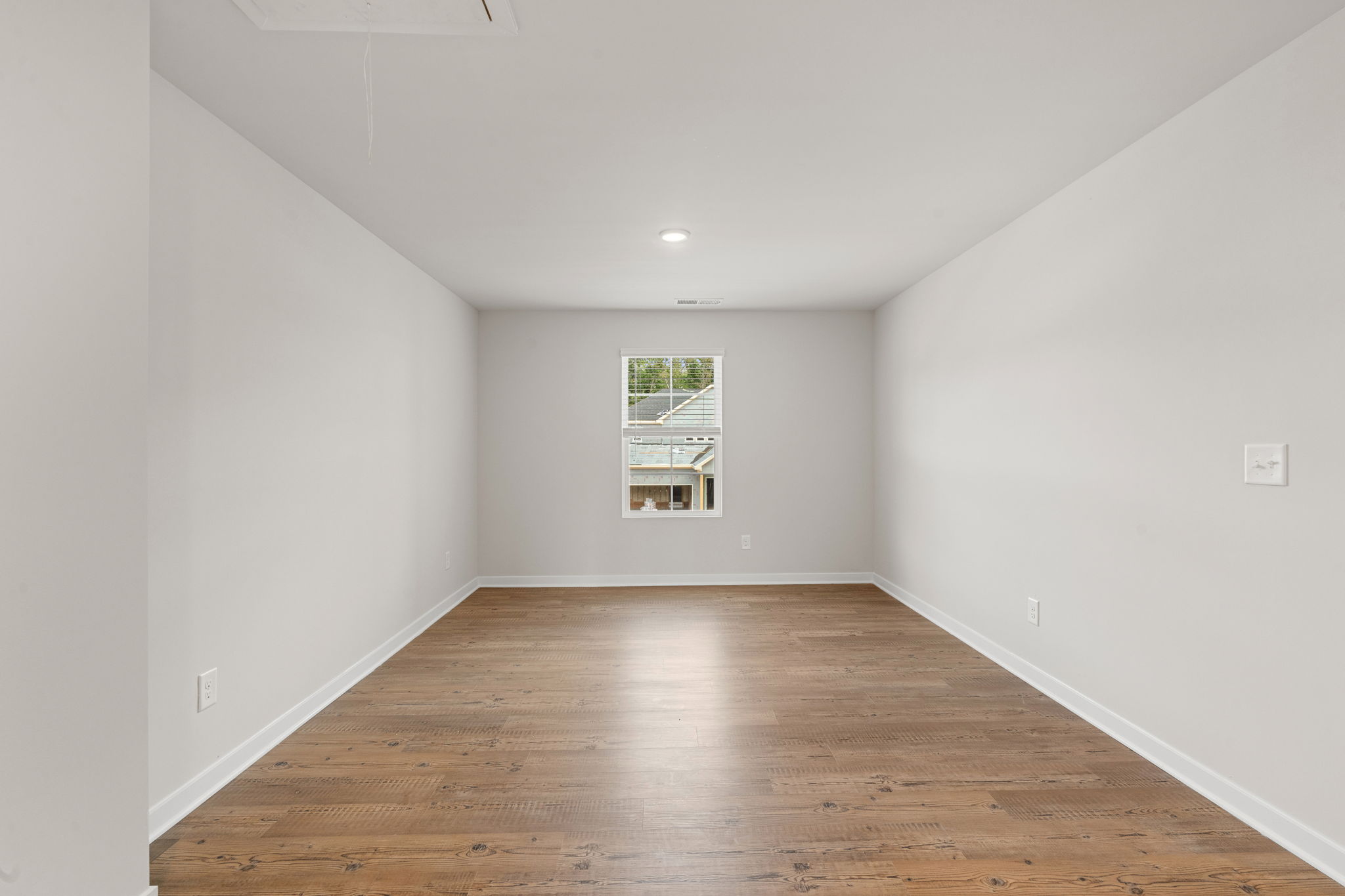 A room with a wood floor and a wood floor.