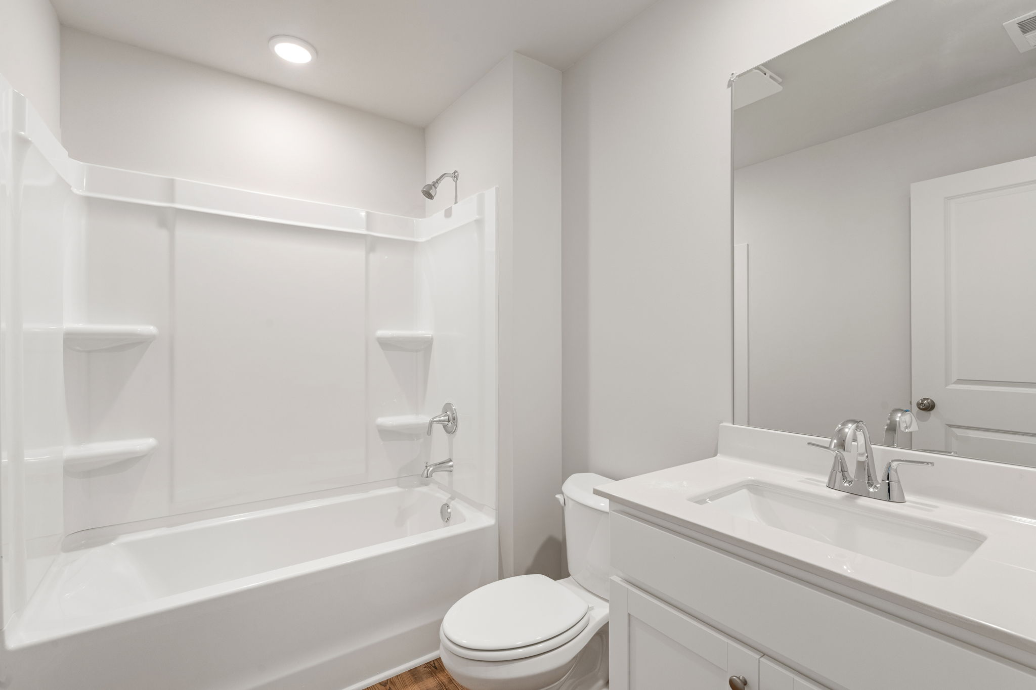 A bathroom with a tub sink and toilet.