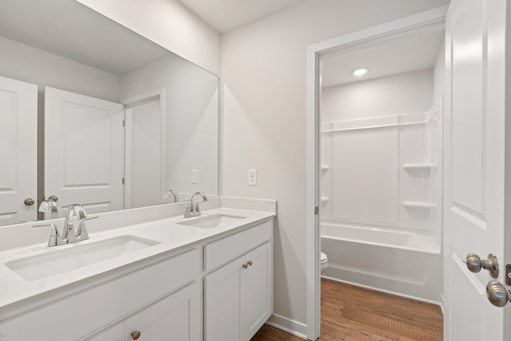 A bathroom with a shower and sink.