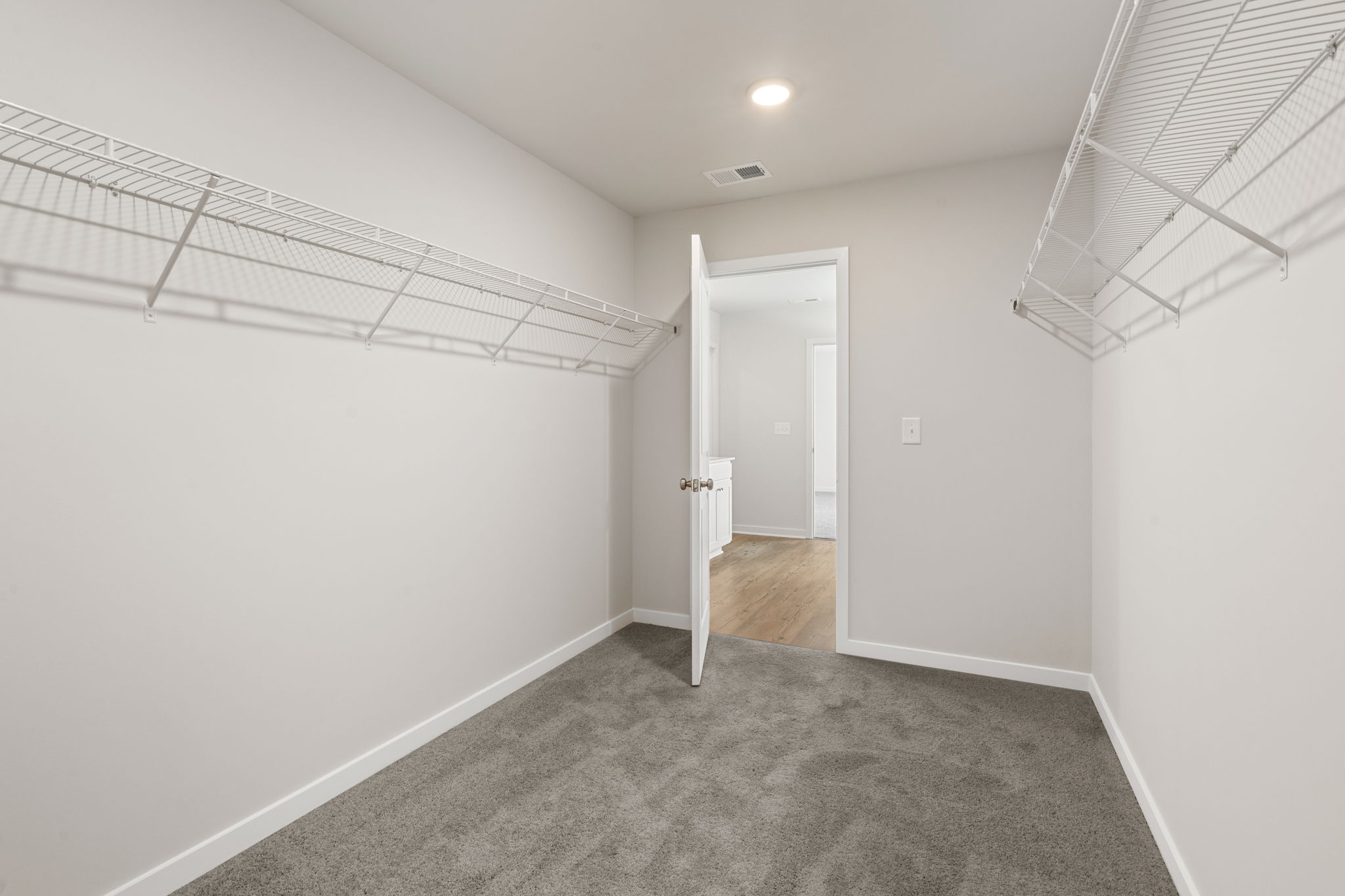 A hallway with white walls.