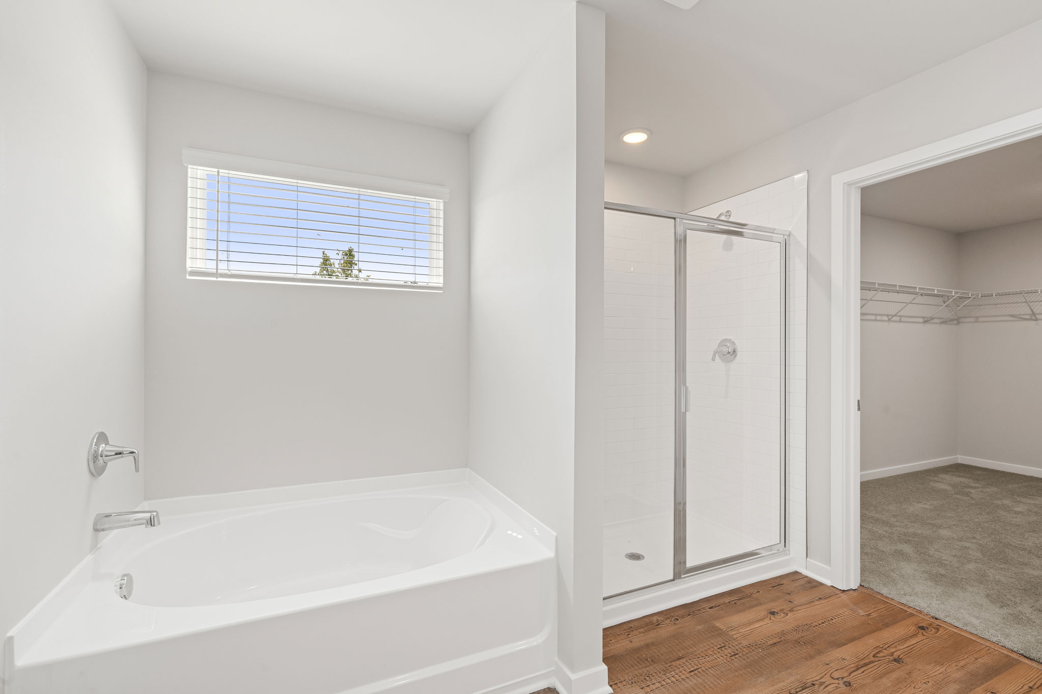 A bathroom with a tub and shower.