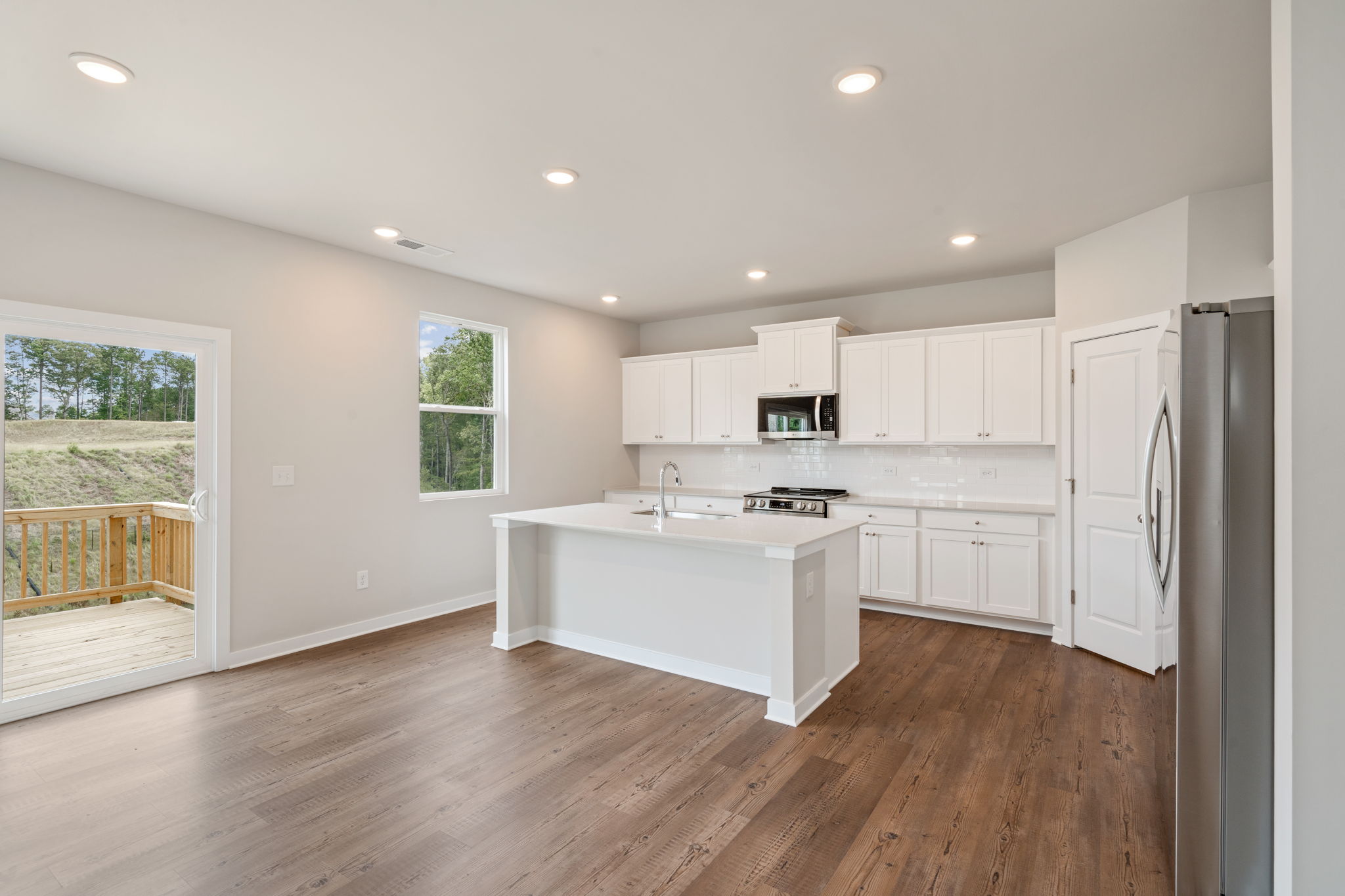A kitchen with white cabinets.