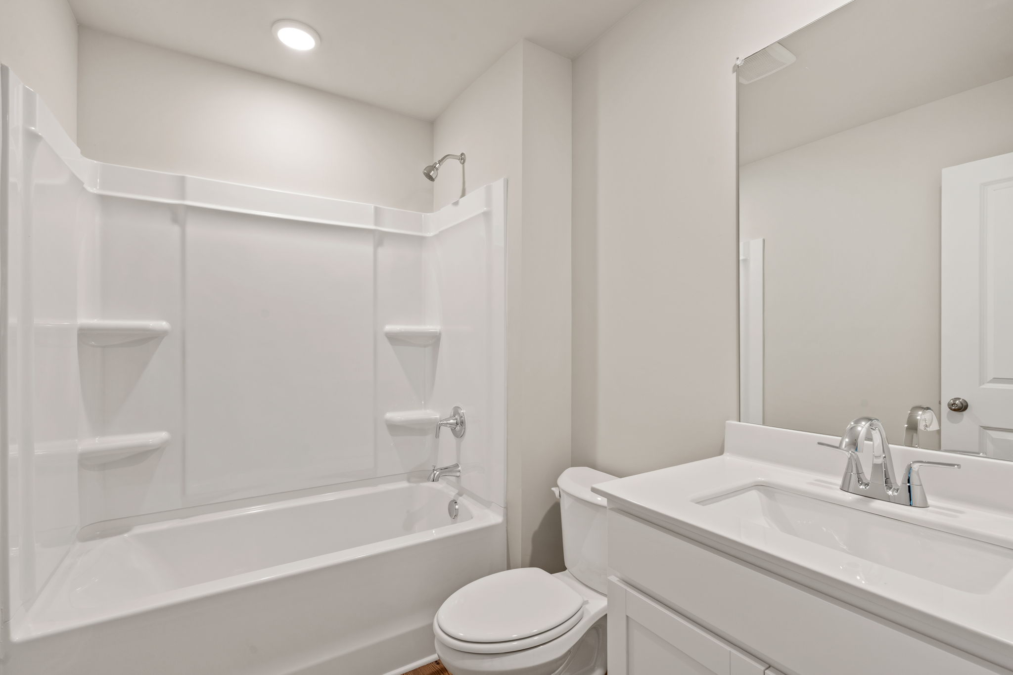 A bathroom with a tub toilet and sink.