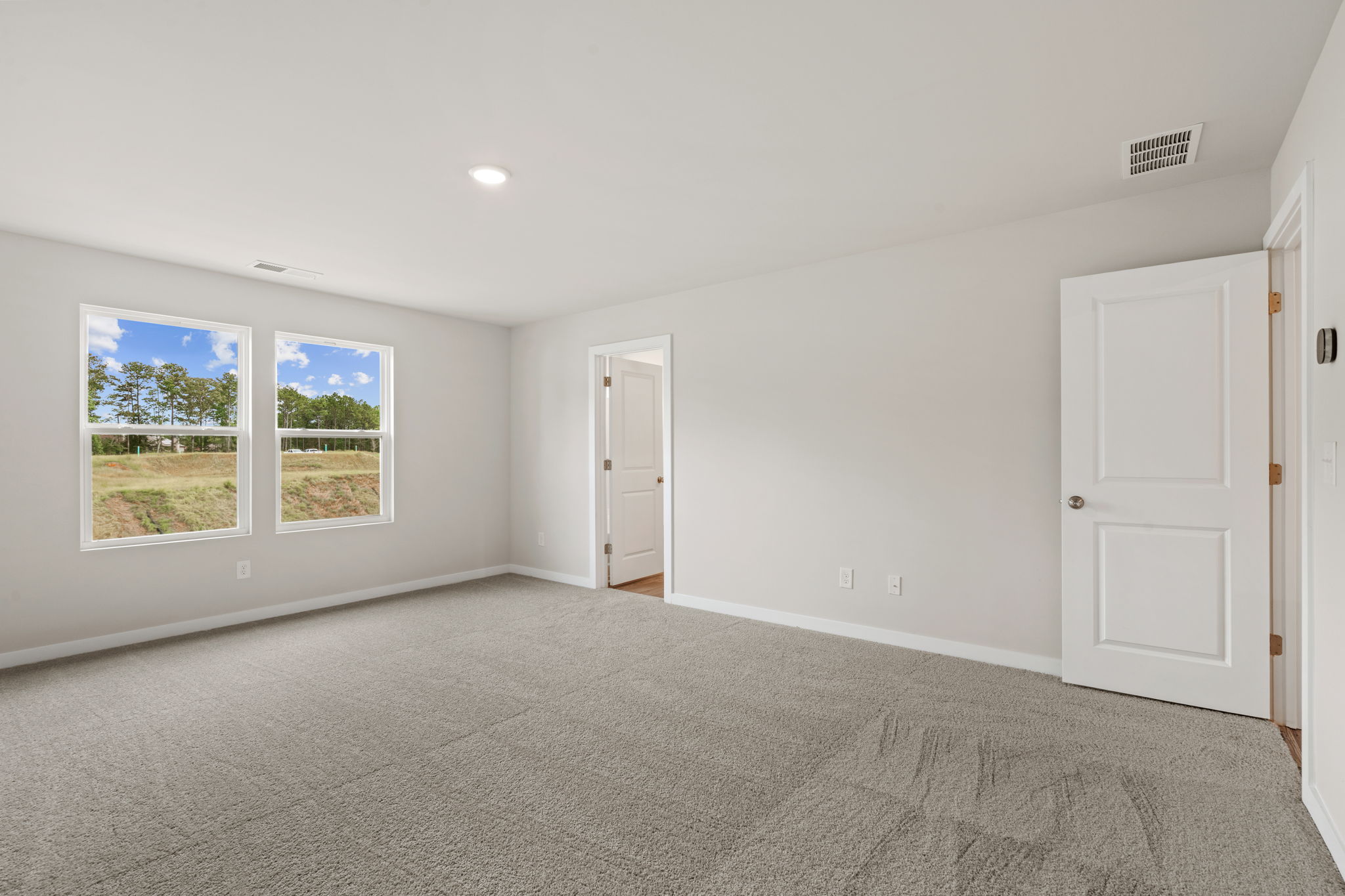 A room with white walls and windows.