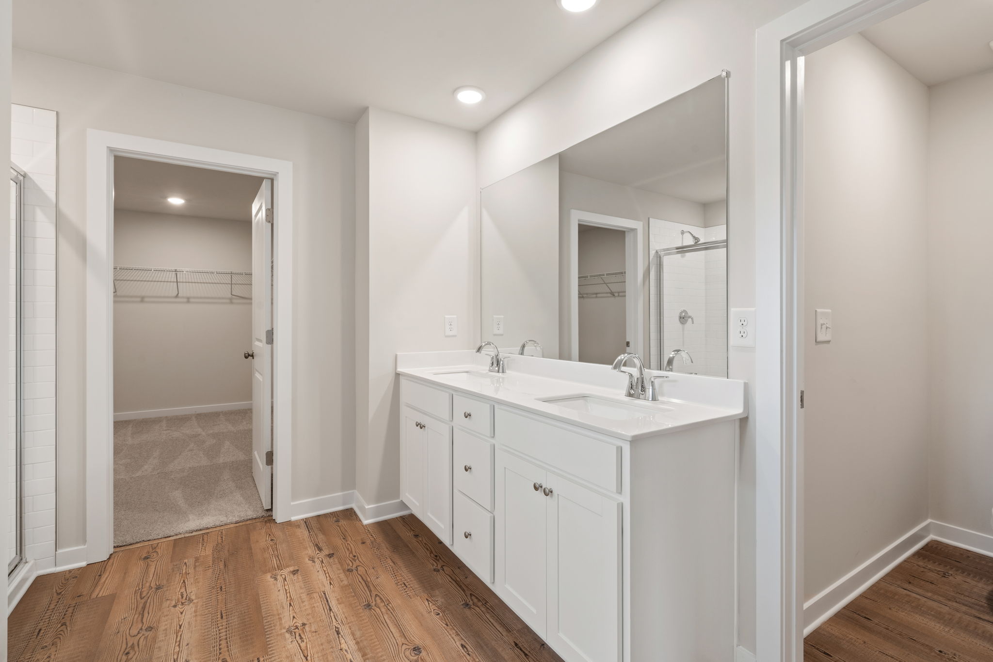 A bathroom with white cabinets.