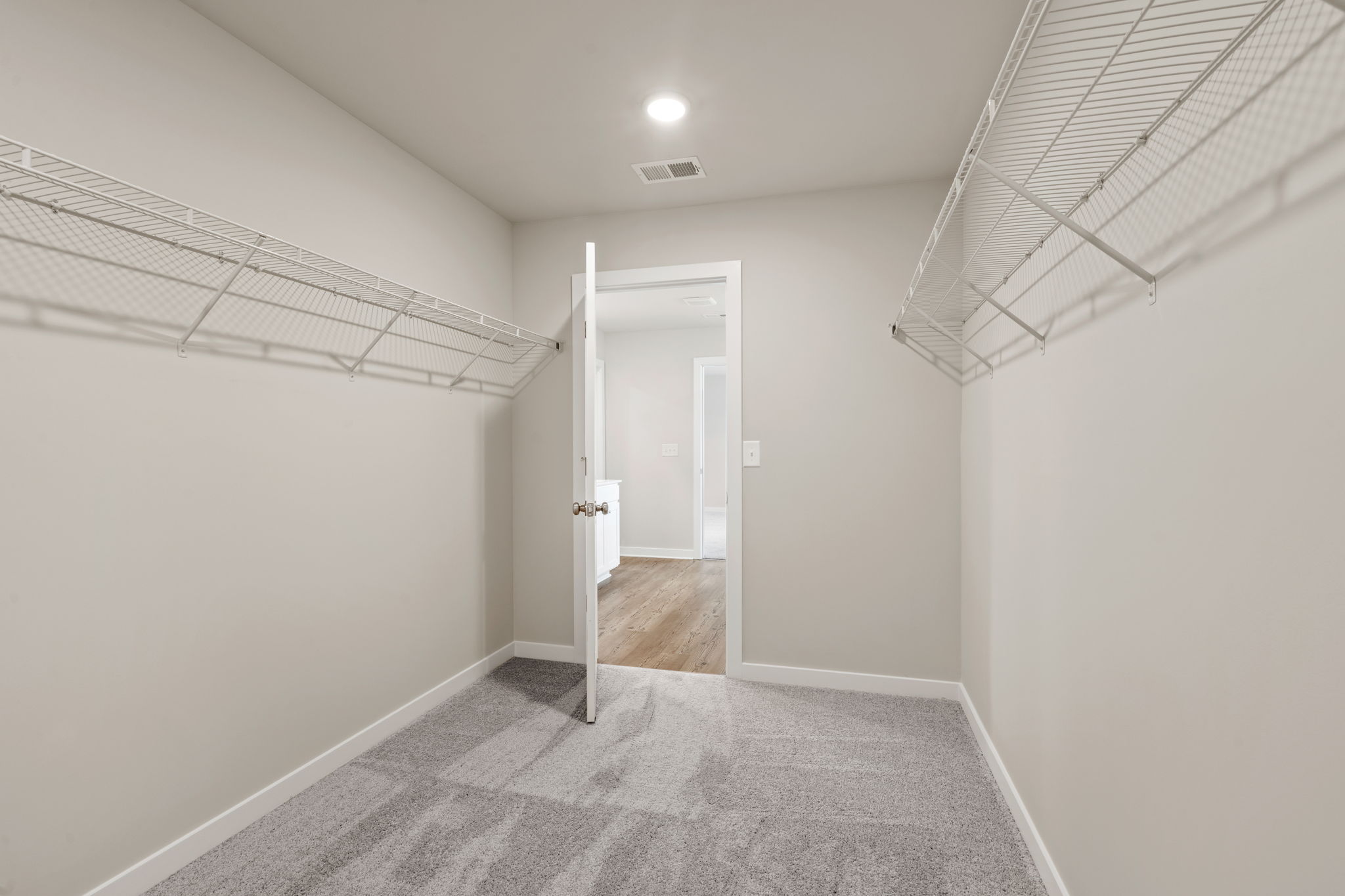 A hallway with white walls.