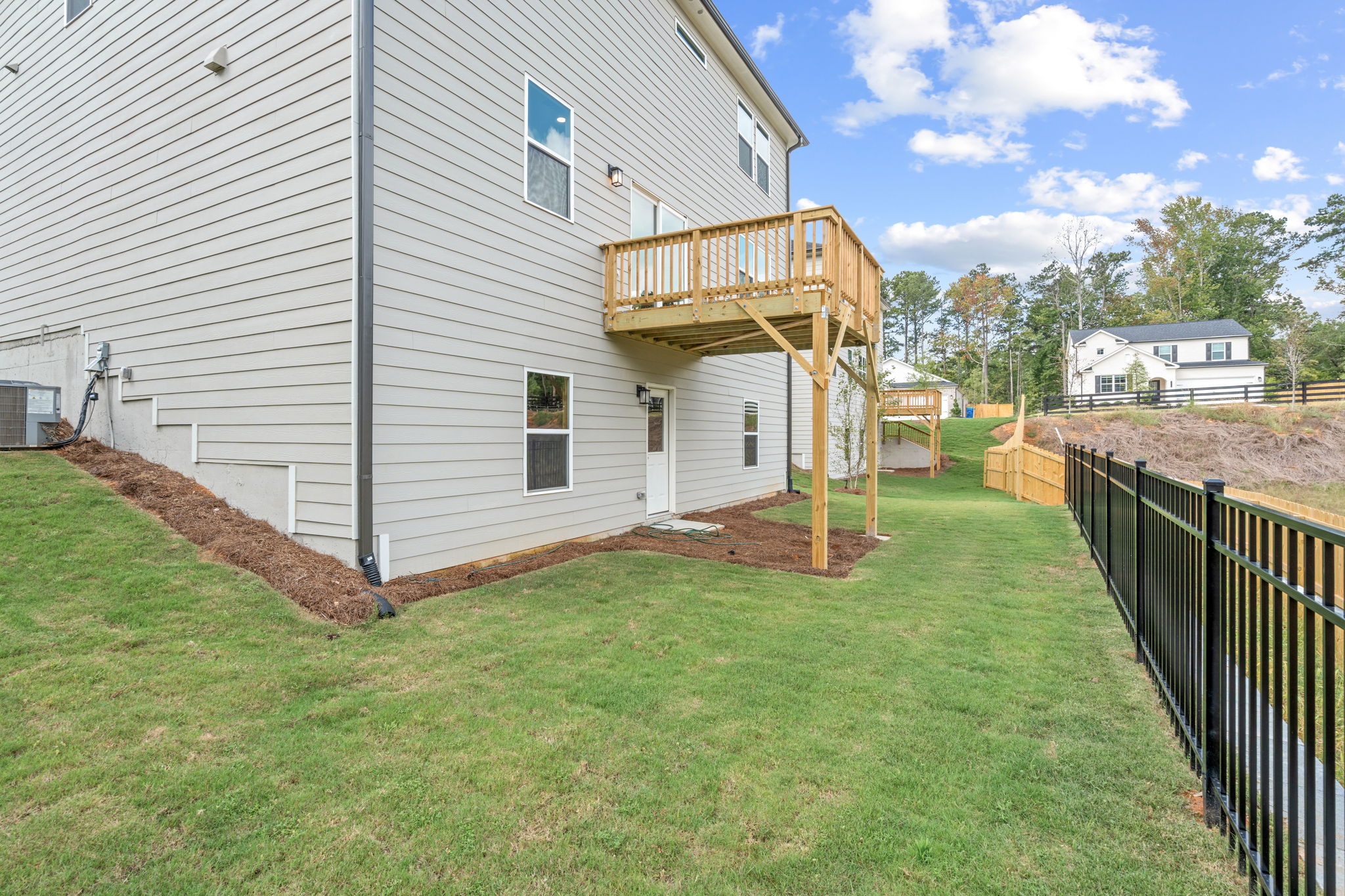 A house with a fence and a yard with a dirt yard.