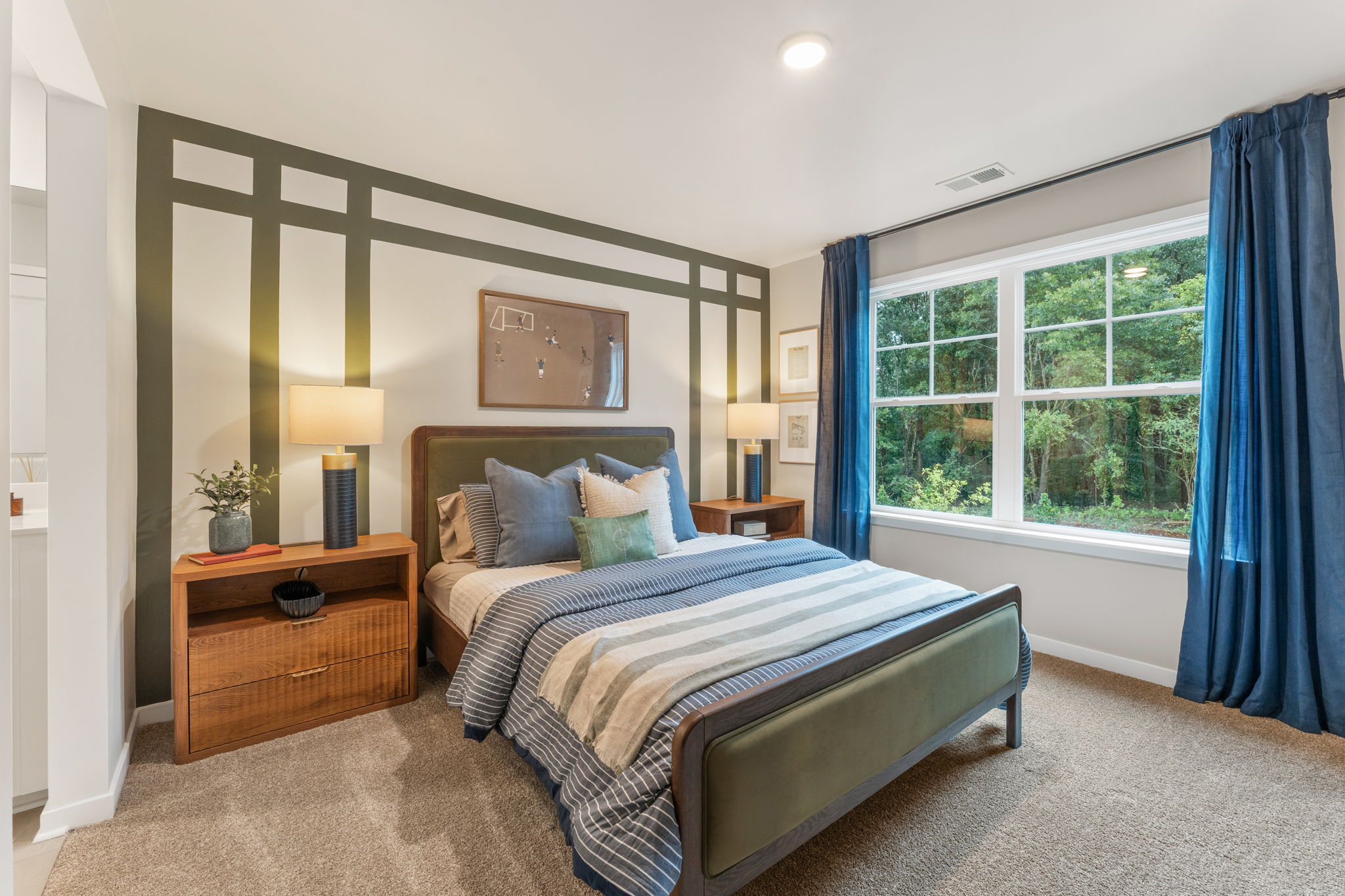 A bedroom with a bed and a window.