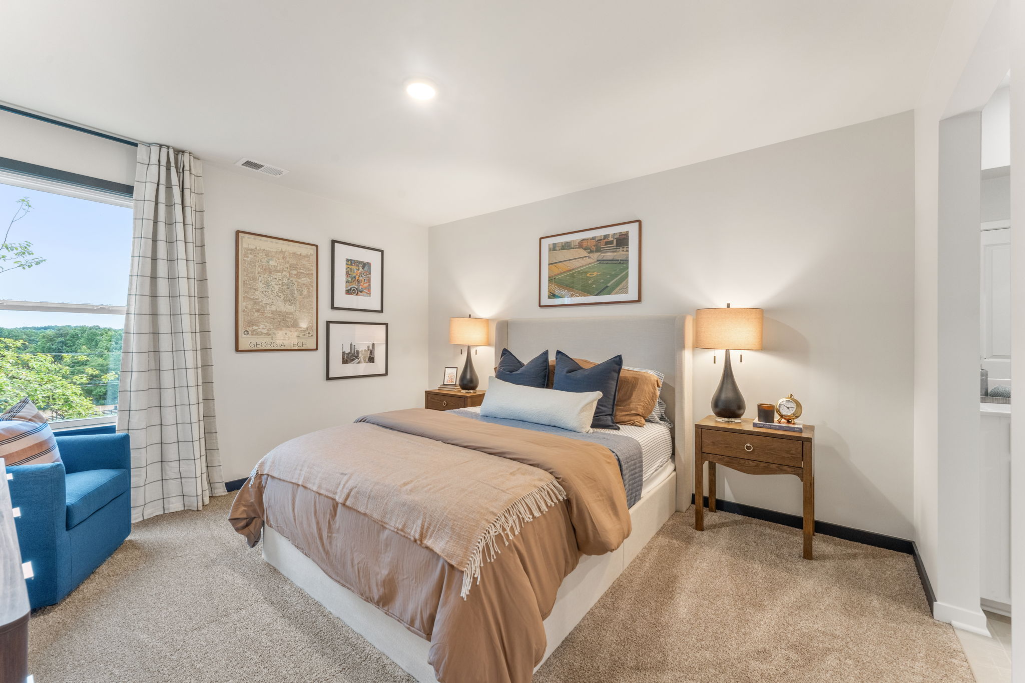 A bedroom with a large window.