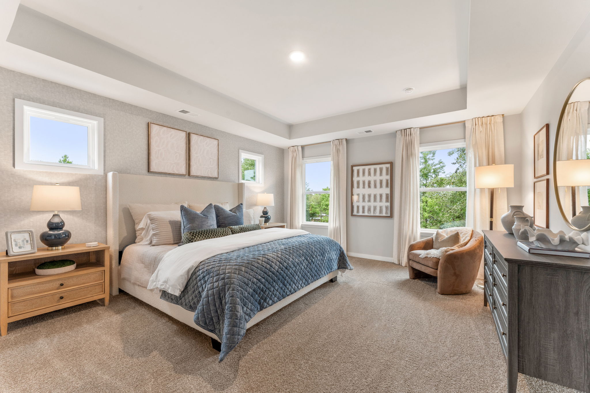 A bedroom with a bed and a chair.