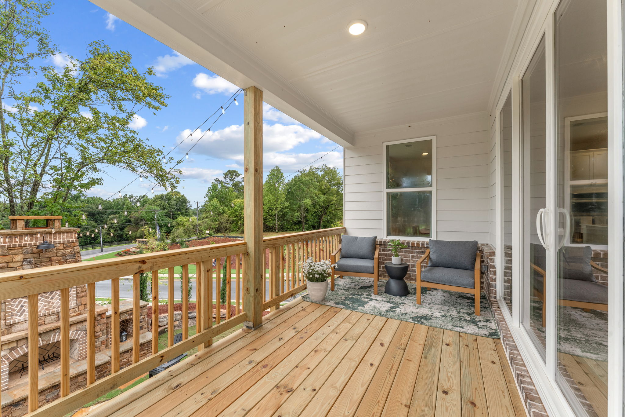 A deck with a chair and a table on it.
