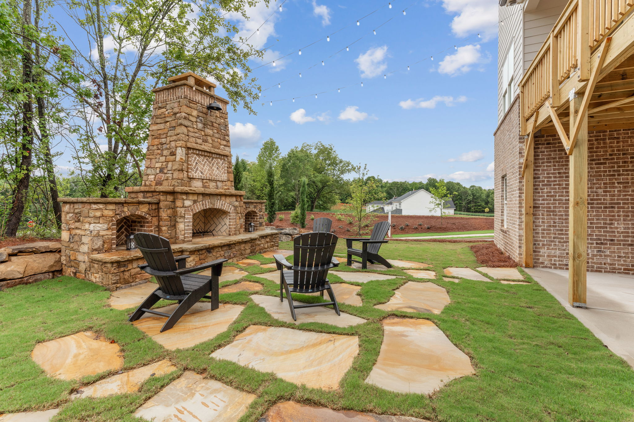 A patio with chairs and a table.
