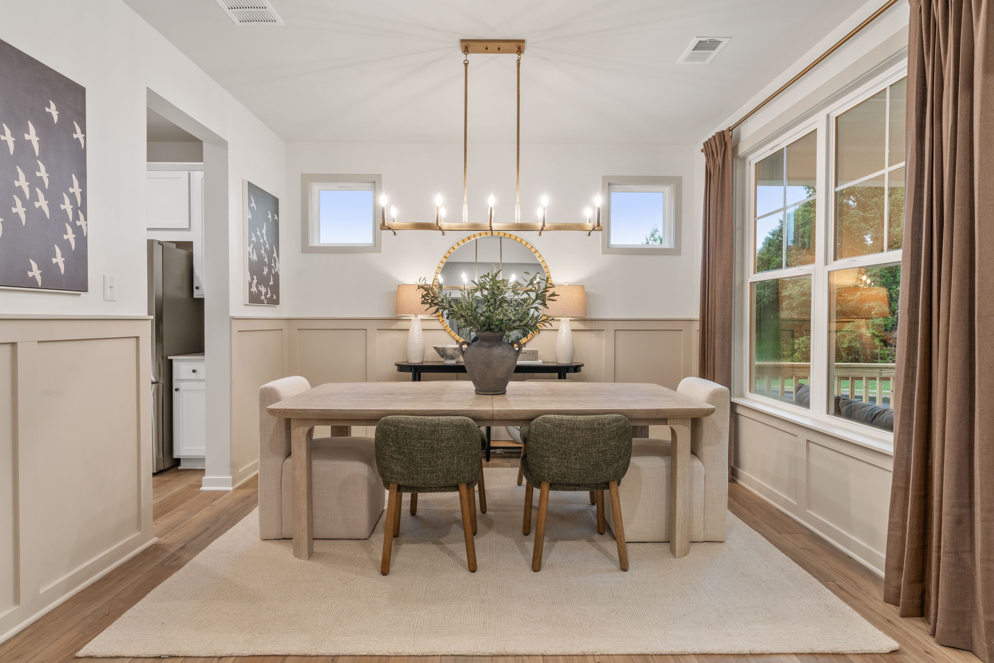 A dining room with a chandelier and chairs.