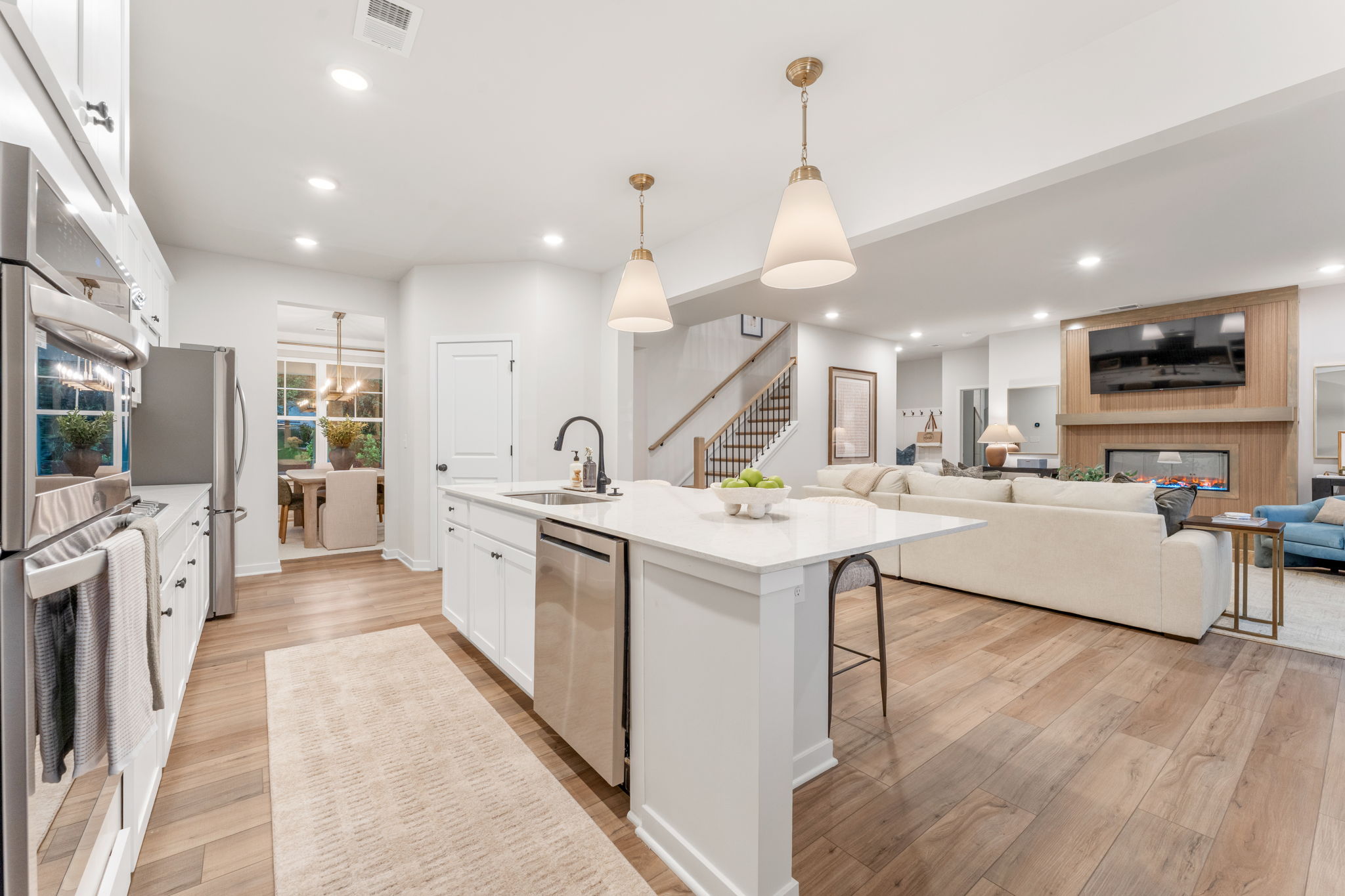 A kitchen with white cabinets.