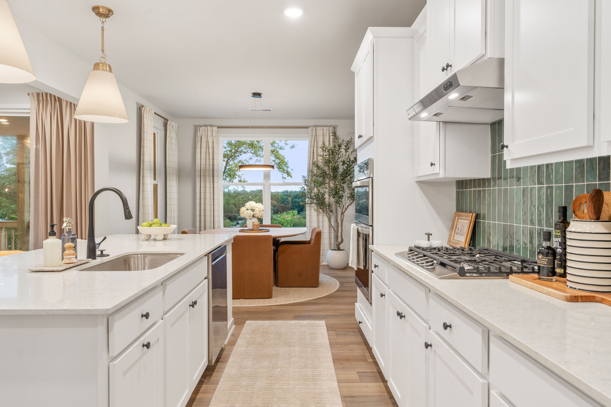 A kitchen with white cabinets.