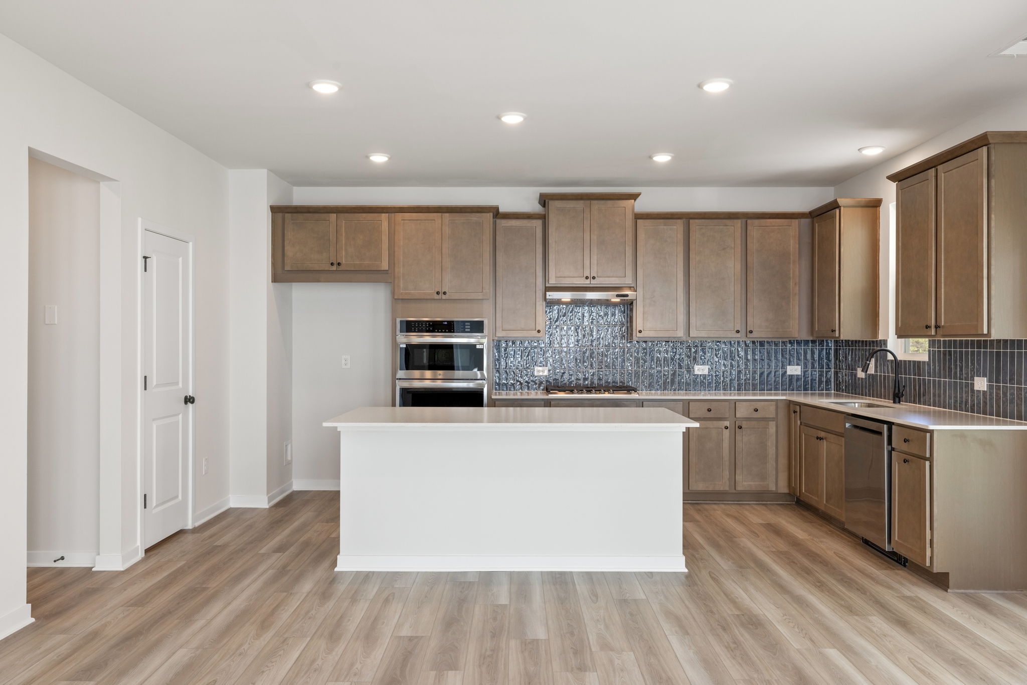 A kitchen with wooden cabinets.
