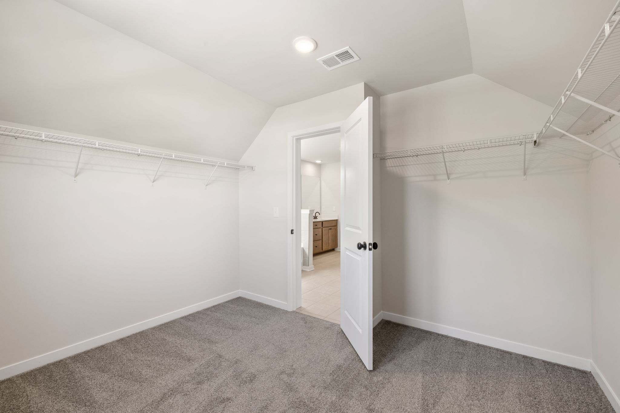 A hallway with white walls.