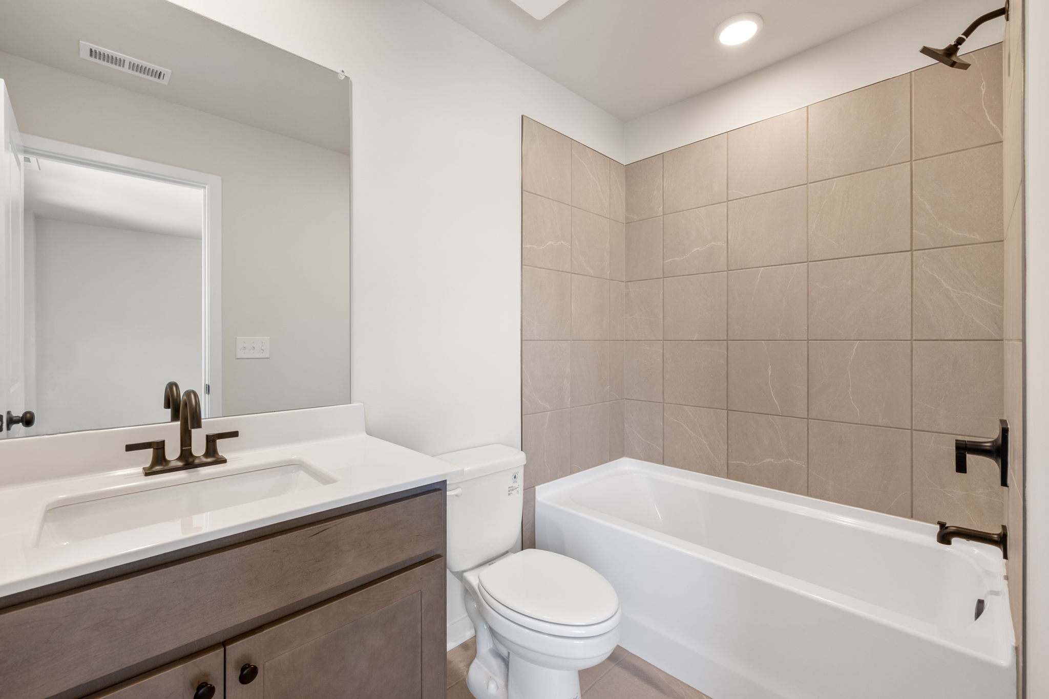 A bathroom with a tub sink and toilet.
