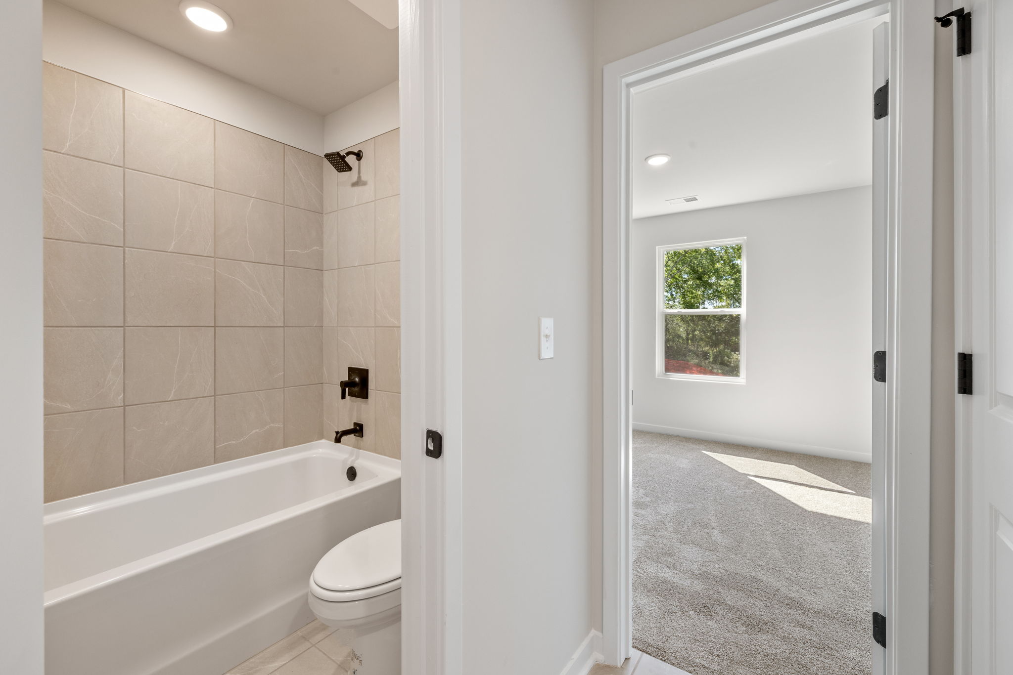 A bathroom with a tub toilet and sink.