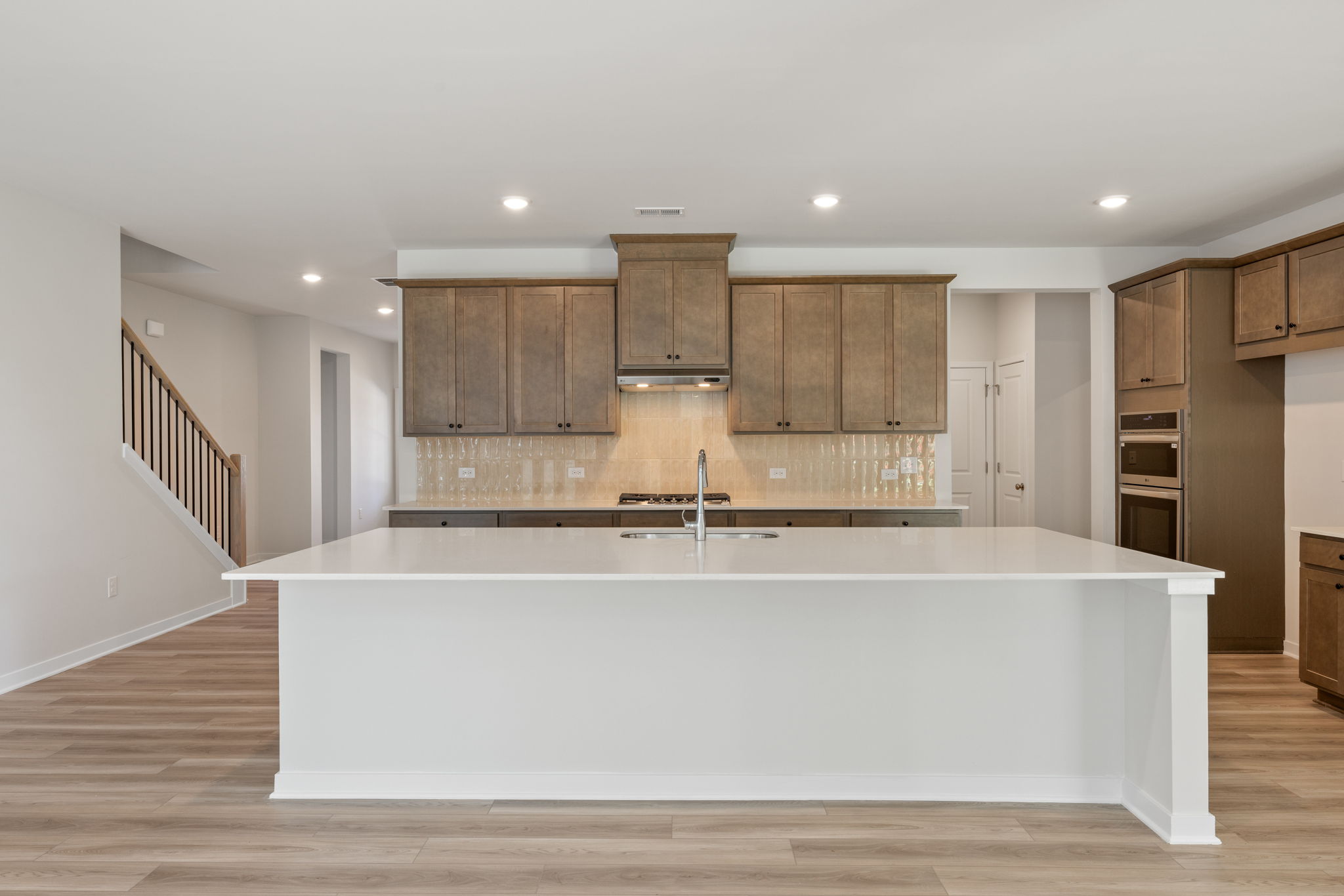 A kitchen with wooden cabinets.