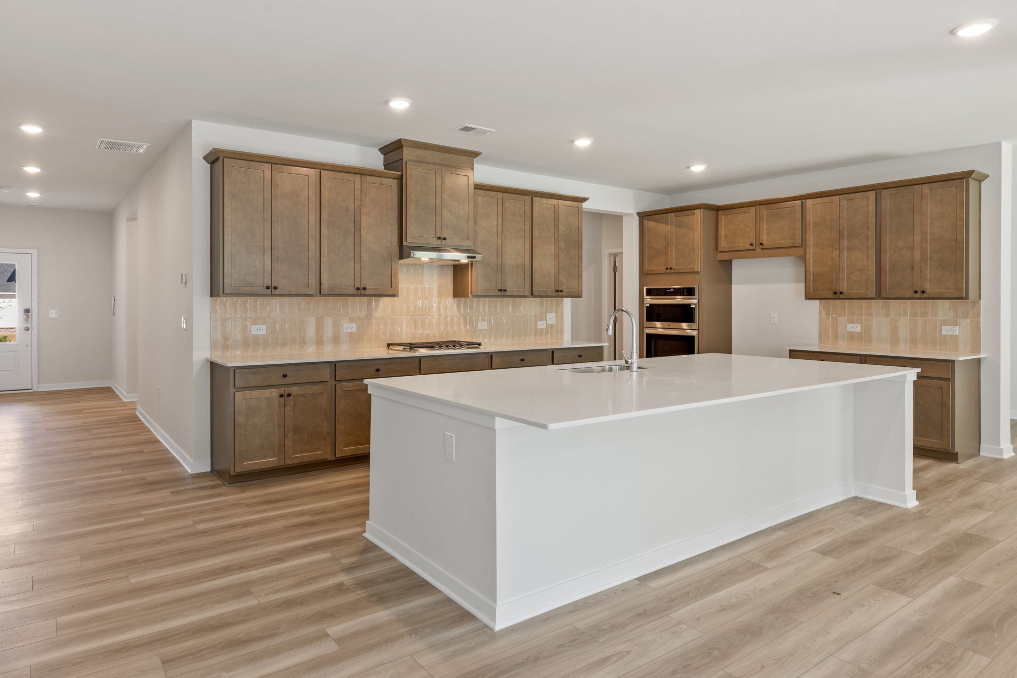 A kitchen with wooden cabinets.