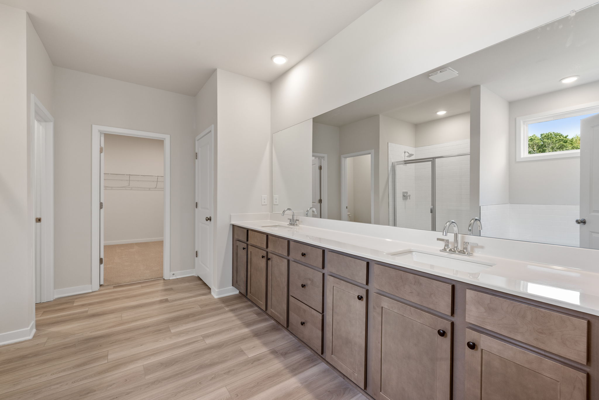 A bathroom with a large mirror.