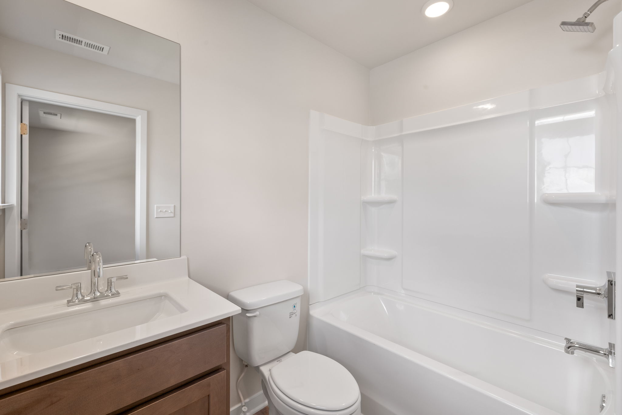 A bathroom with a tub toilet and sink.