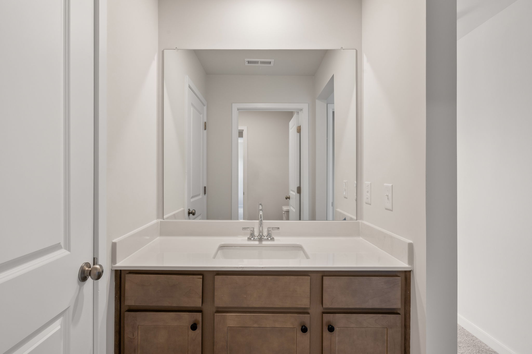 A bathroom with a large mirror.