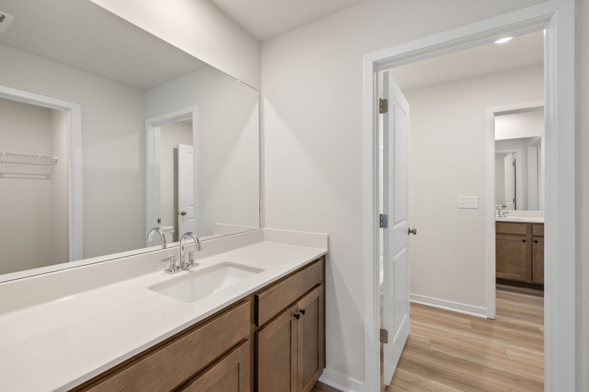 A bathroom with a large mirror.