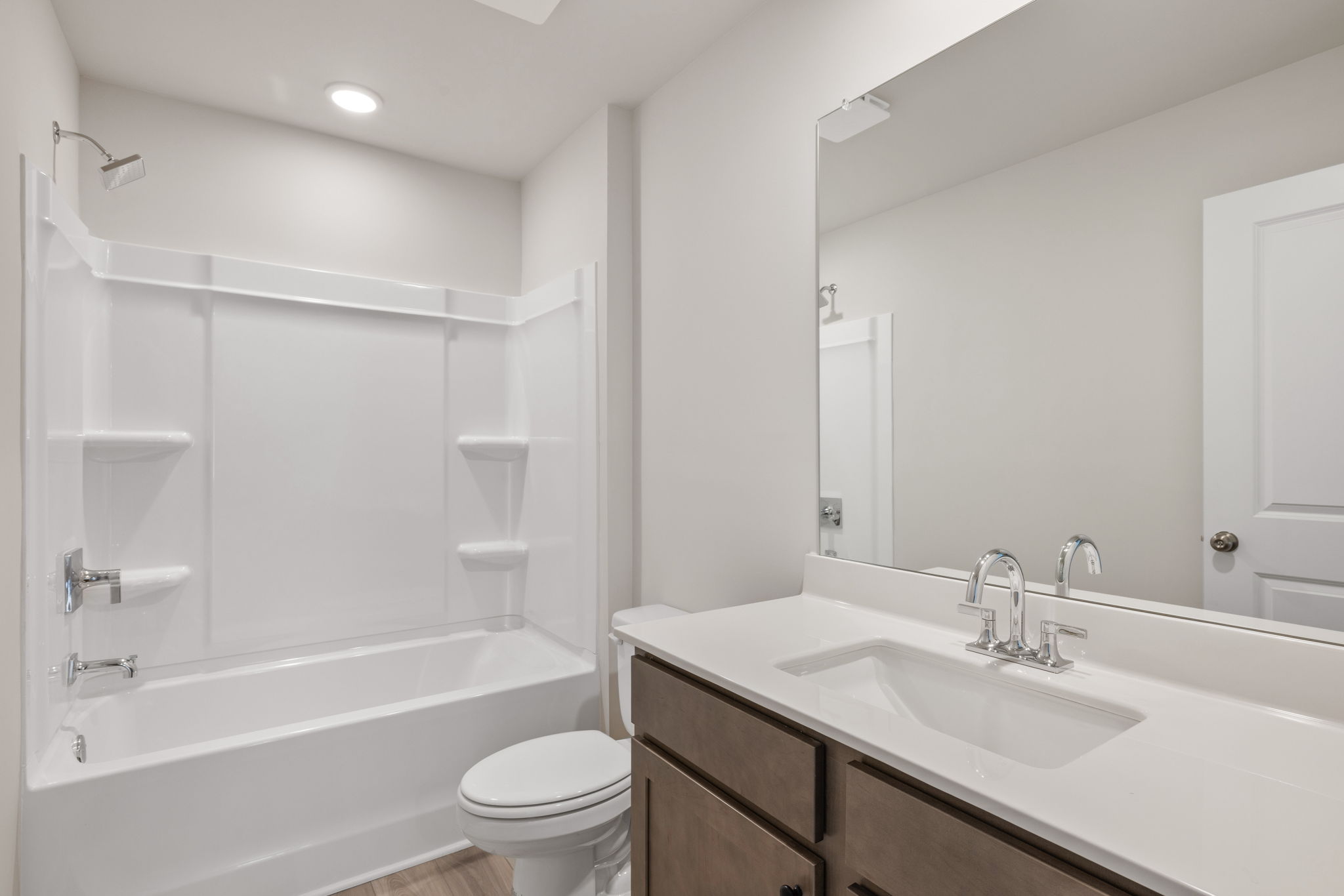 A bathroom with a tub sink and toilet.