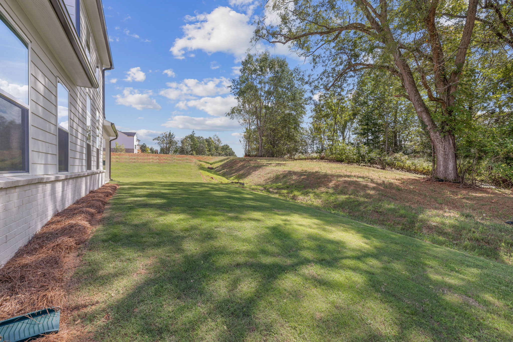 A grassy area next to a building.