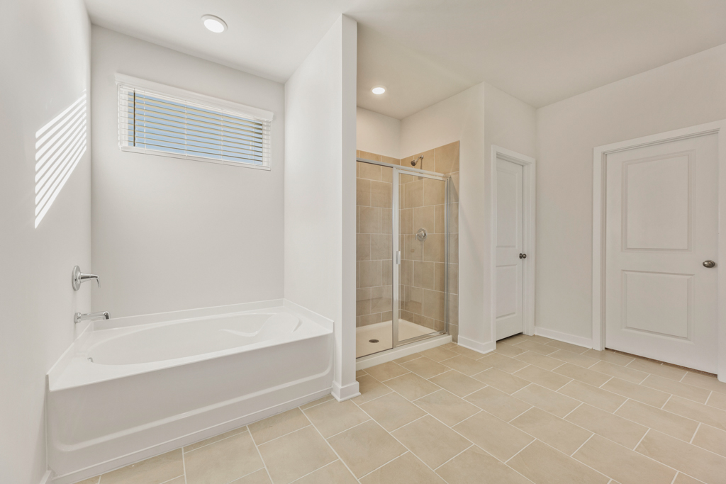 A bathroom with a bathtub and shower.