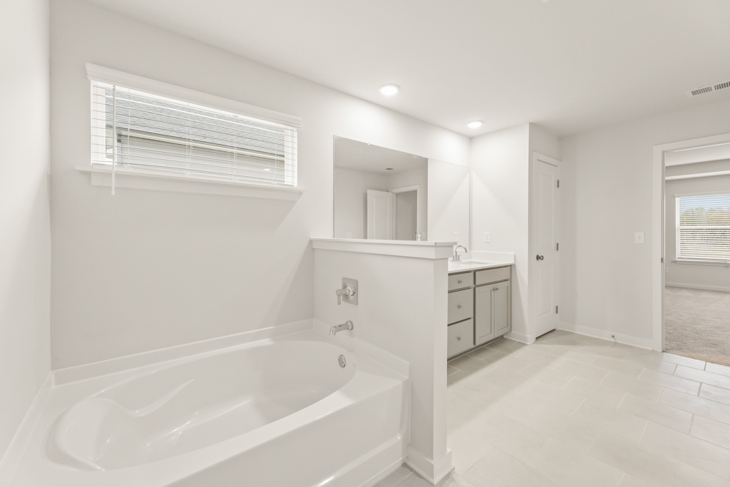 A bathroom with a tub and sink.