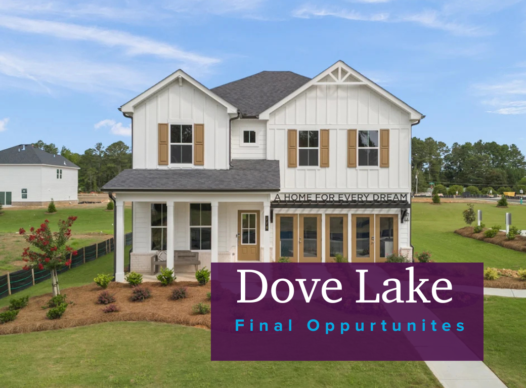 A white house with a sign in front of it.