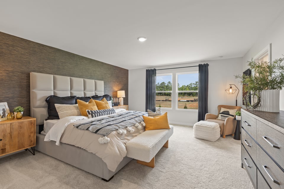 A bedroom with a bed and a couch.