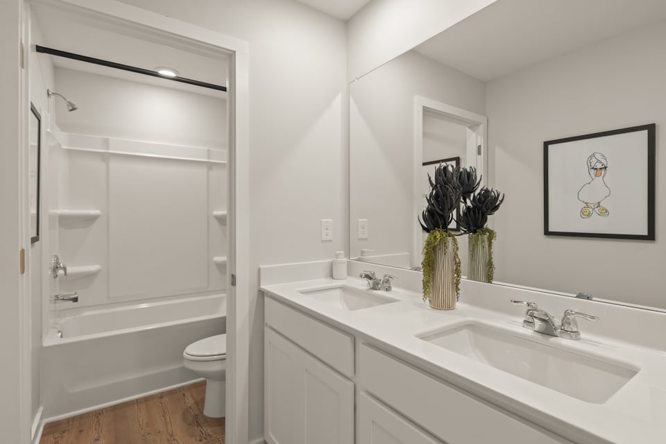 A bathroom with a sink toilet and a shower.
