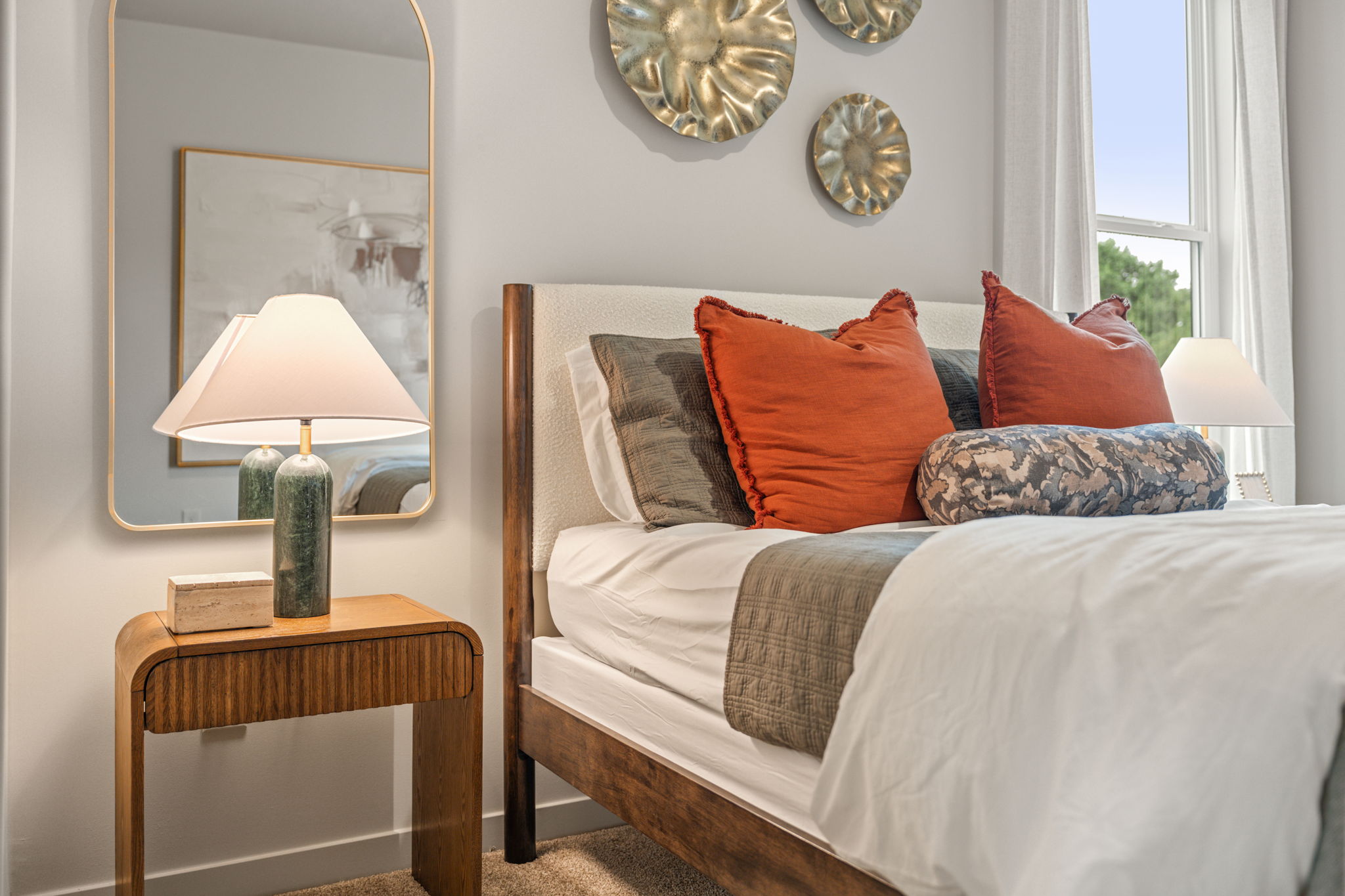 A bed with pillows and a lamp.