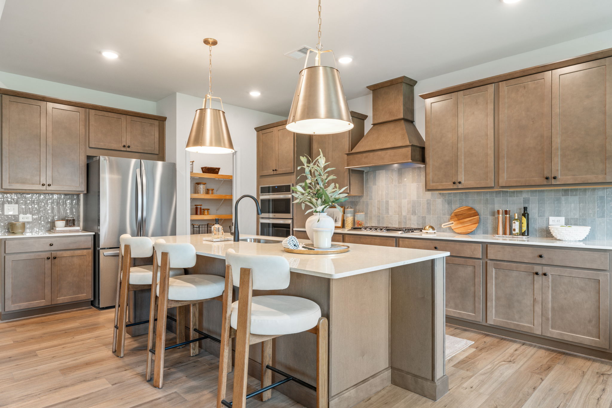 A kitchen with a bar and stools.