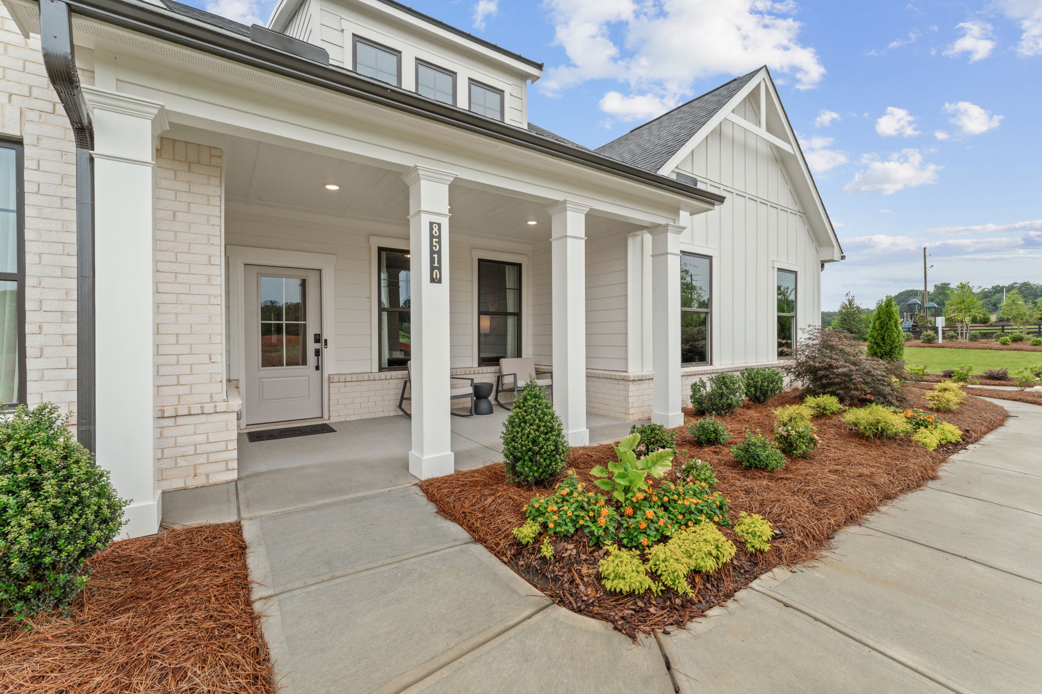 A white house with a driveway.
