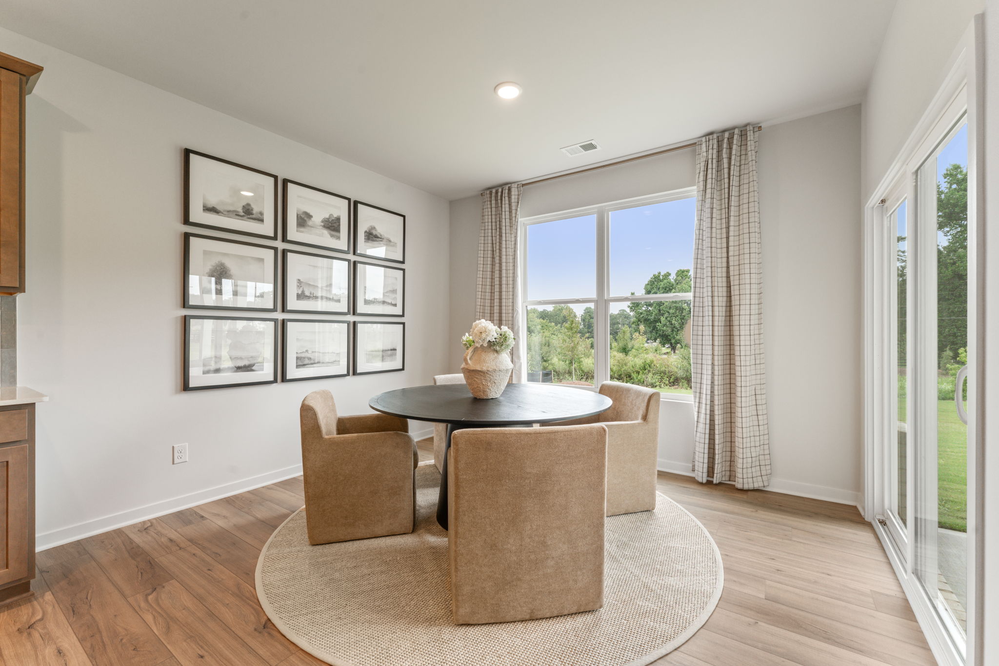 A living room with a large table and chairs.