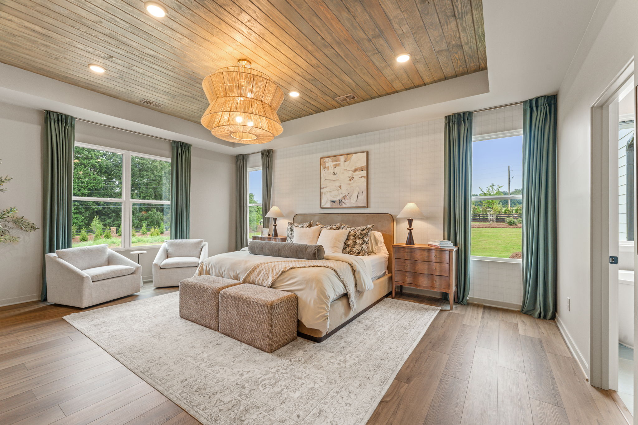 A large bedroom with a large window.